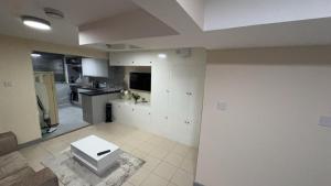 a kitchen with white cabinets and a table in it at Large Studio for Contractors, Families, Relocation Near New Cross Hospital in Monmore Green