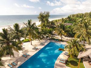 an aerial view of a resort with a pool and the beach at Kisiwa on the Beach in Paje