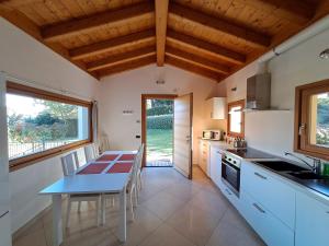 a kitchen with a table and a dining room at Villa Primula in Bellagio