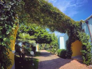 an entrance to a building covered in ivy at Villaggio Porticello Mare in Vieste