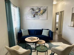 a living room with a blue couch and chairs at Affordable Stay Near Proctors A2 in Schenectady +22 photos