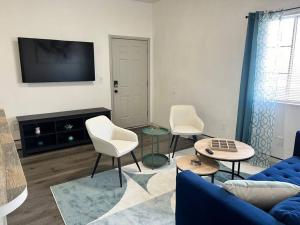a living room with a blue couch and two chairs at Affordable Stay Near Proctors A2 in Schenectady