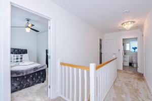 a white hallway with a stairway leading to a bedroom at Hasting's House by YourStays - 3 Bedroom House in Stoke-on-Trent in Stoke on Trent +97 photos