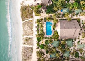 an aerial view of a resort with a swimming pool at Kisiwa on the Beach in Paje