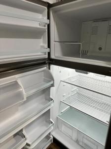 an open refrigerator with its door open and its shelves at Affordable Stay Near Proctors A8 in Schenectady