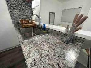 a kitchen with a sink and a counter top at Affordable Stay Near Proctors A8 in Schenectady +30 photos