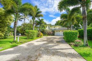 a house with palm trees and a driveway at Blue Hawaii House in Princeville