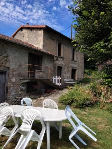 a white table and chairs in front of a house at Maison Vintage in Marat