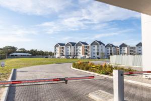 an empty street in front of apartment buildings at Infinite Tide Bellamare in Summerstrand