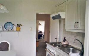 a kitchen with a sink and a counter top at Unterm-Reetdach-Whg-3 in Borkum +2 photos