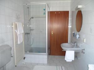 a bathroom with a shower and a sink and a shower at Unterm-Reetdach-2 in Borkum
