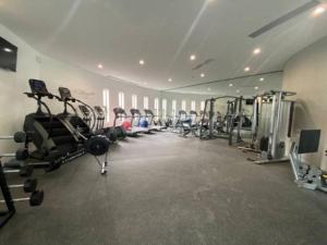 a gym with rows of treadmills and machines at Acogedor Ubicadismo 1R 4Pax in Querétaro