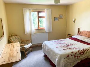 a bedroom with a bed and a window at Chestnut Lodge - Uk38194 in Chittoe