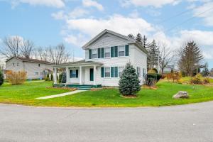 a white house with a christmas tree in the yard at 5 Mi to Lake Ontario Mexico Home with Seasonal Pool in Mexico