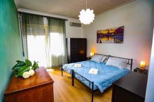 a bedroom with a blue bed in a room at Domus Antica Trastevere in Rome