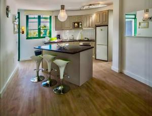 a kitchen with a island with bar stools in it at Villa Casa Aloe Vera in Playa Blanca +10 photos