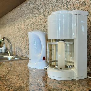 a white blender sitting on a counter next to a sink at Green House in Calheta