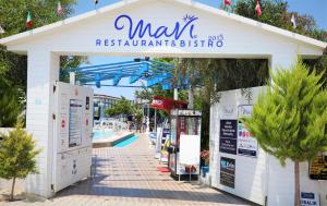 a building with a sign that reads max restaurant and bistro at Mavi Restaurant & Apartments 3 in Didim