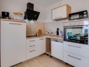 a kitchen with white cabinets and a sink at Magic Sea View - Apartments Rina in Karlobag