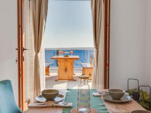 a dining room with a table and a view of the ocean at Magic Sea View - Apartments Rina in Karlobag +28 photos
