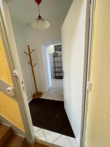 a hallway with a cross on the wall and a stairway at La Langouste ROUGE in Camaret-sur-Mer