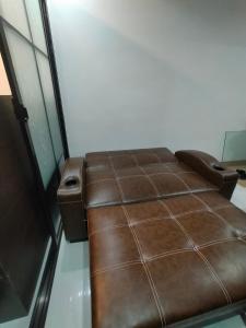a brown leather couch sitting in a room at Northern Vacation Homes - Selendra in Baguio