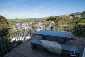a blue bench sitting on top of a balcony at Ultimate Coastal Escape - Stylish & Estuary Views in Salcombe
