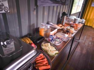 a table with a buffet of food on it at MOTO Inn URUBICI in Urubici