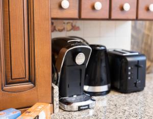 a kitchen counter with two coffee makers on a counter at Impala Sinaia - Kudu in Sinaia