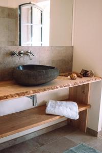 a bathroom counter with a sink and a mirror at Chambre tout confort à l'Héritier - au coeur du Tarn in Marzens