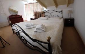 a bedroom with a bed with towels on it at Victoria Mansion in Pinakokhórion