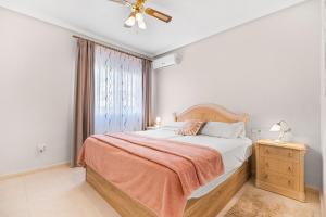 a bedroom with a bed and a window at Villa Quesada in Rojales +23 photos