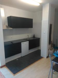 a kitchen with a sink and a tv on the wall at 2 bedroom Apartment Falésia Beach in Albufeira