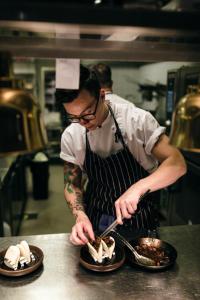 a man in a kitchen preparing food on a counter at Generator Stockholm in Stockholm +37 photos