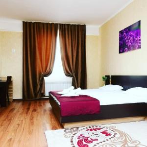 a hotel room with two beds and a window at Alatau Hotel in Astana