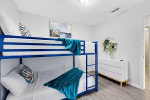 a bedroom with two bunk beds in a room at Oasis 317 - Space to Unwind in Titusville +36 photos