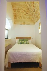 Ένα ή περισσότερα κρεβάτια σε δωμάτιο στο Colle dei Monaci Luxury Homes