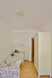 a white room with a table and a dining room at Casa Lorelei in Riomaggiore +50 photos