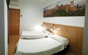 A bed or beds in a room at Hostal Restaurante Cornella