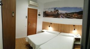 A bed or beds in a room at Hostal Restaurante Cornella