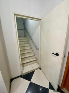 a staircase in a room with a glass door at Golden Apart Hotel in Aparecida +14 photos