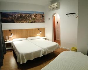 A bed or beds in a room at Hostal Restaurante Cornella