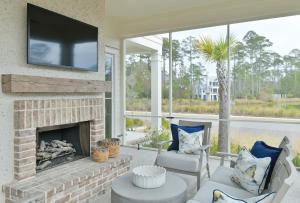 a living room with a fireplace with a flat screen tv at Lagoon View 3 Bedroom Moreland Village Home 5602 in Bluffton