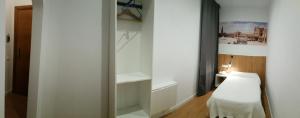 A bed or beds in a room at Hostal Restaurante Cornella