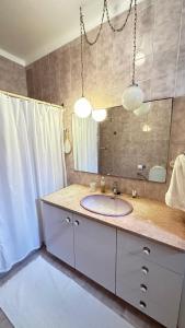 a bathroom with a sink and a mirror at Casa Sol e Mar by Férias em Figueira in Figueira da Foz +46 photos