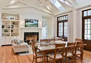 a dining room with a table and chairs and a fireplace at Signature 3 Bedroom Residence 1008 in Bluffton