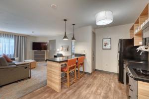 an open kitchen and living room in a apartment at Candlewood Suites Milwaukee Airport - Oak Creek by IHG in Greendale