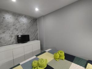 a room with three yellow rubber ducks sitting on a bed at Arenas 50, 100 mt d playa ingles in Playa del Ingles +10 photos