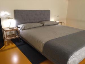 a bedroom with a large bed with two night stands at Duomo House in Milan