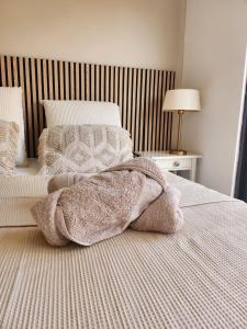 a bedroom with a bed with a blanket on it at Boa Mindelo Beach in Mindelo +56 photos